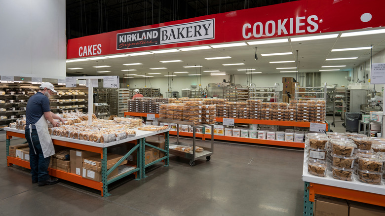 Costco employee arranging baked goods at the store's bakery