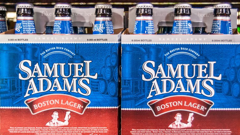 Closeup of display on shelf of Samuel Adams Boston Lager beer in six-packs.