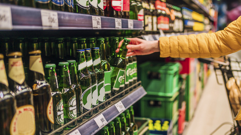 Hand-picking beer out at store.