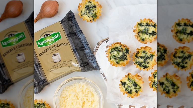 A block of Kerrygold Reserve cheddar cheese next to puff pastry bites
