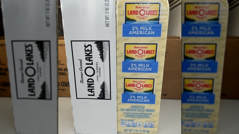 A package of Land O Lakes American cheese next to a large box of cheese