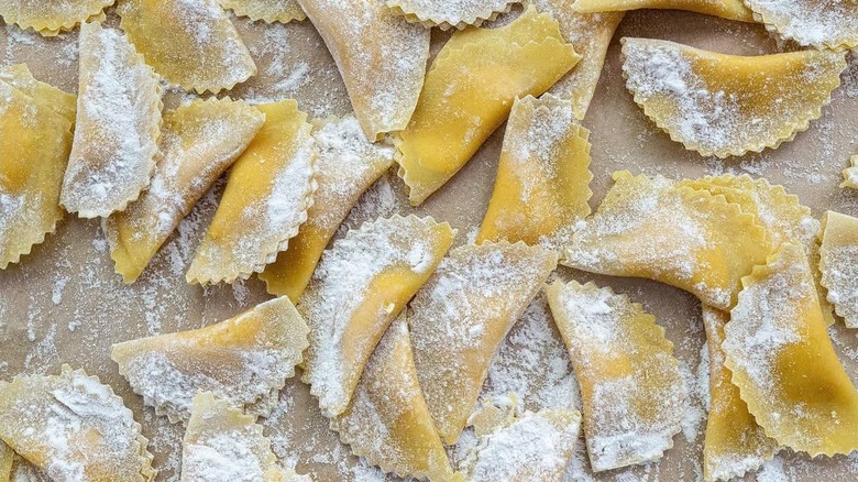Homemade pumpkin ravioli tossed in flour before cooking