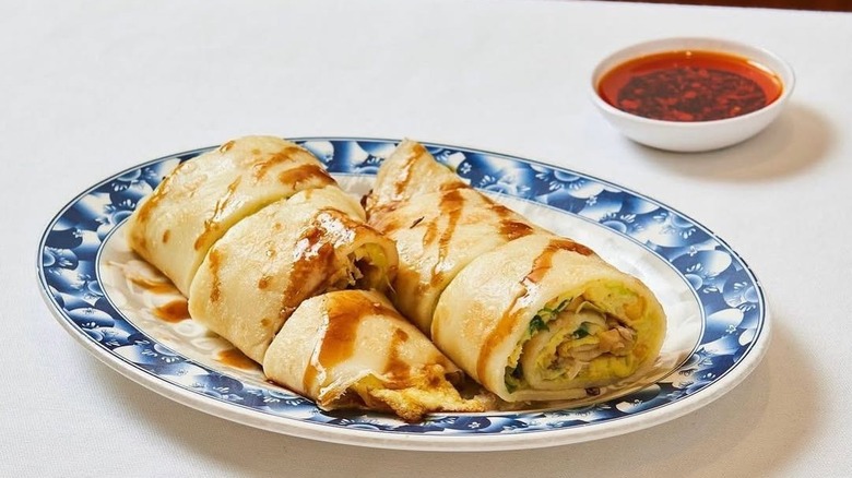 A Tawianese crepe with scallions and eggs on a plate