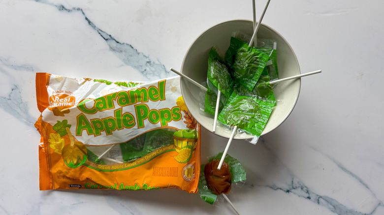 Tootsie caramel apple pops on marble surface
