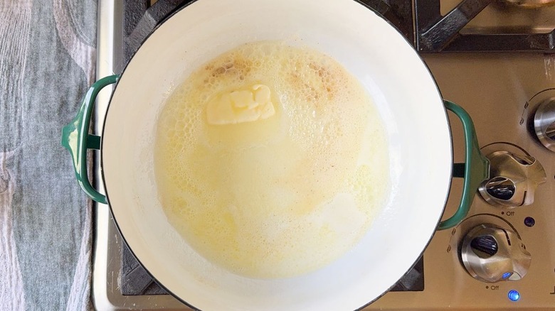 butter melting in large pot on stovetop