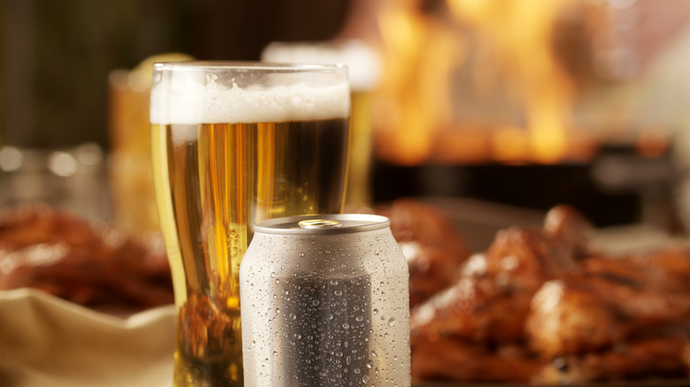 Can and glass of beer with chicken