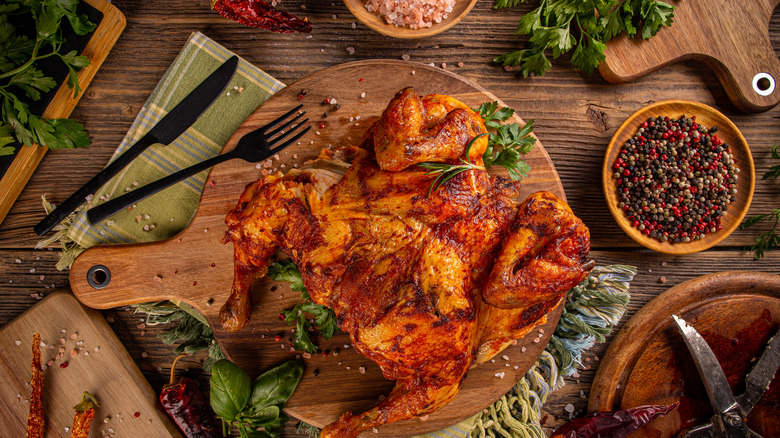 Whole spicy chicken on cutting board