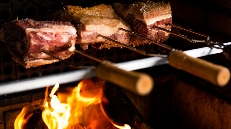 Meats roating over flame