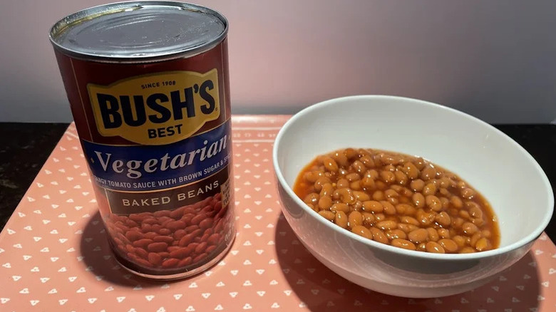 Bush's Best Vegetarian Baked Beans can next to a bowl of the same baked beans