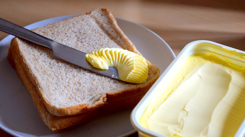 spreading margarine on bread