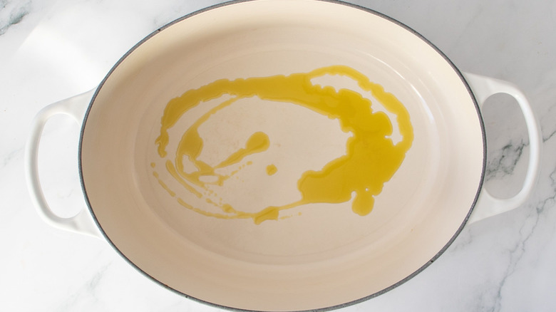 Olive oil drizzled in Dutch oven