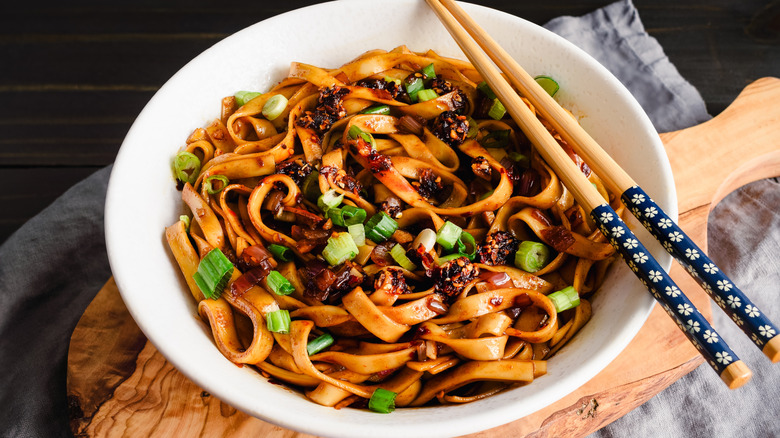 A bowl of noodles with chili crisp mixed in