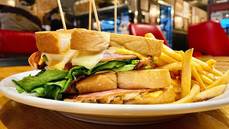 The Amazing Island Club on a plate with fries at Bardog Tavern