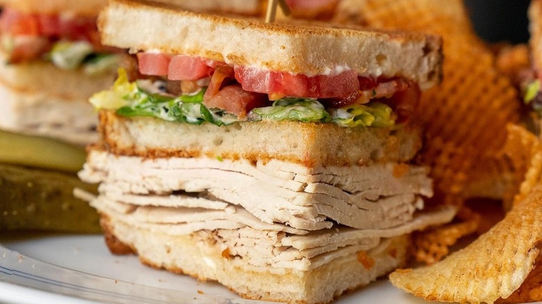 A club sandwich at Mark's Off Madison on a plate