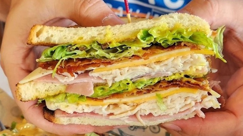 A person holding the King Club at McAlister's Deli