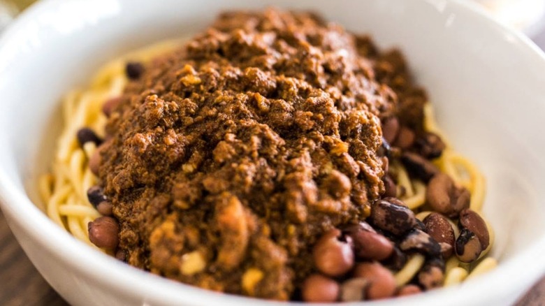 Bowl of chili with beans on spaghetti