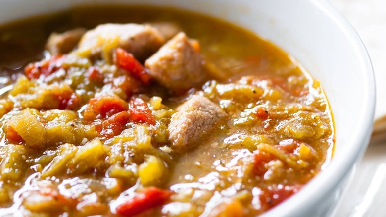 Bowl of green chili with pork pieces