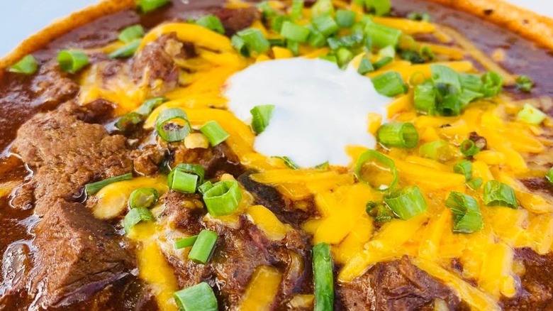 Brisket chili with cheese, green onions, and sour cream
