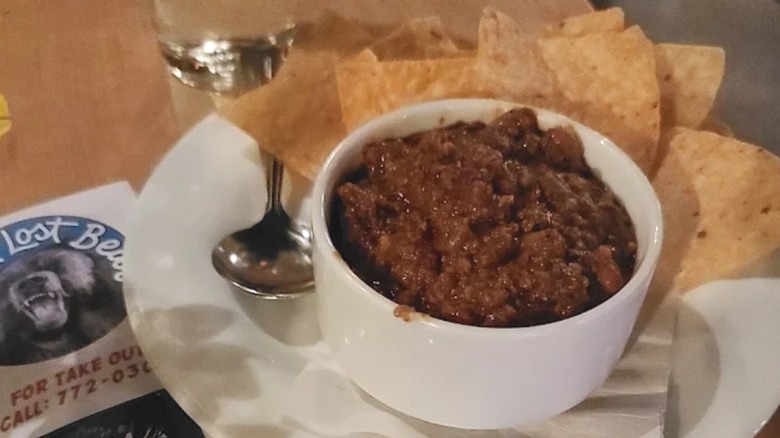 Bowl of chili with spoon and tortilla chips