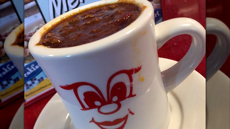 Chili in a white mug with smiling red face graphic