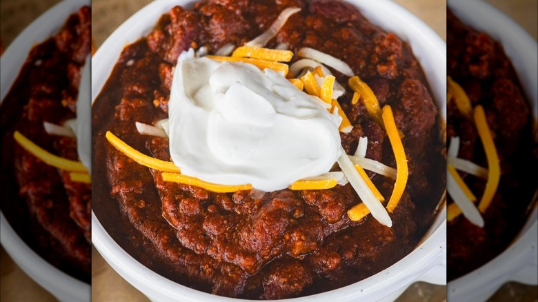 Bowl of chili with sour cream and cheese
