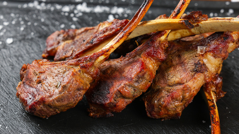 Grilled lamb chops stacked on each other.