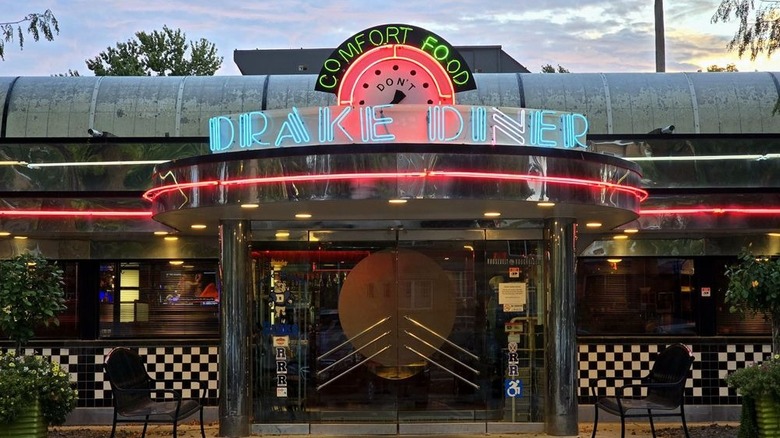 Front entrance of Drake Diner with its blue and red neon sign