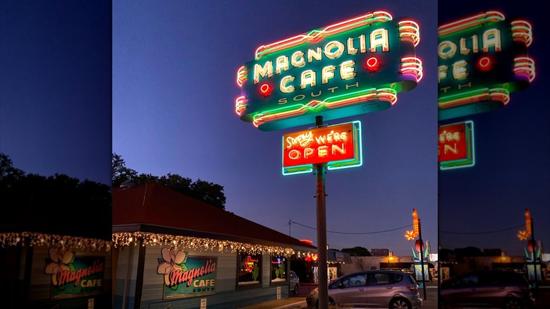 Exterior of Magnolia Cafe, including sign, at night