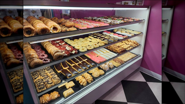 Display case full of donuts inside Holey Moley Daylight Donuts