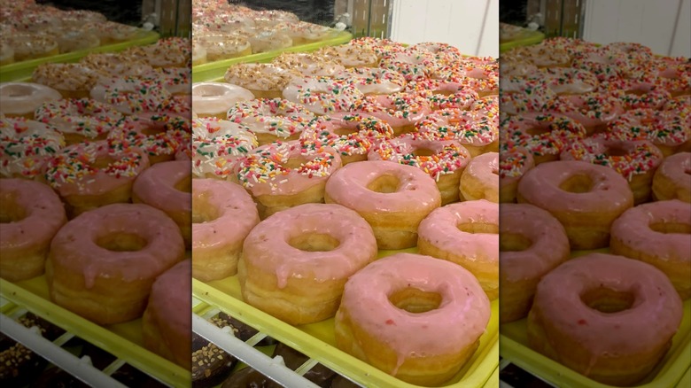 Tray of pink-frosted donuts from The Donut Palace
