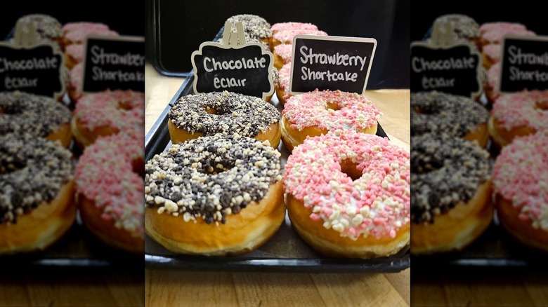 Close up of chocolate eclair and strawberry shortcake donuts on a tray from Mrs. Murphey's Donuts