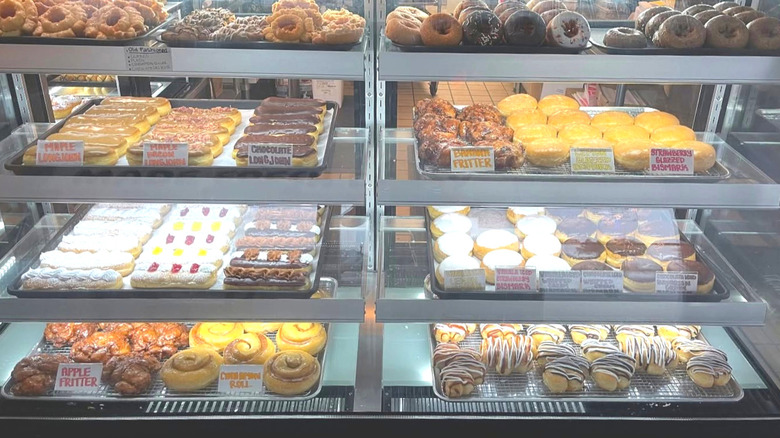 Display case full of different donuts at Luna Donut