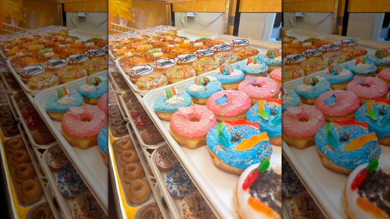 Trays of fun decorated donuts on display at Delight Donut