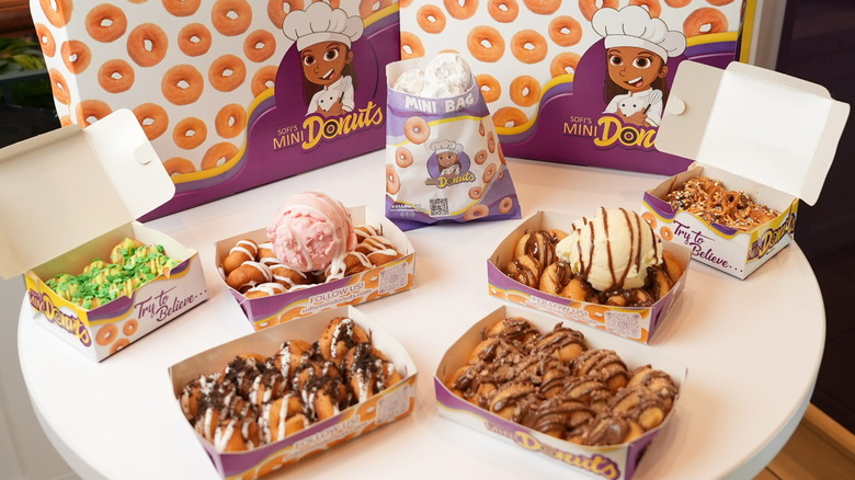 Table display showcasing various donuts from Sofi's Mini Donuts