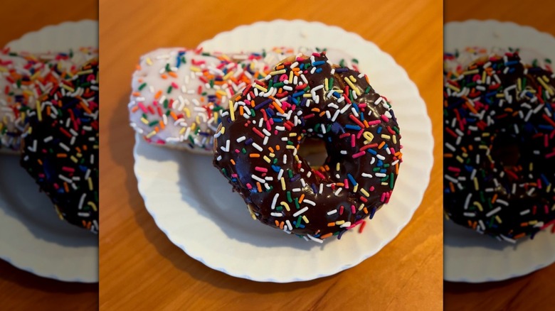 Close up of two donuts with sprinkles on a white plate from Fosdal Home Bakery