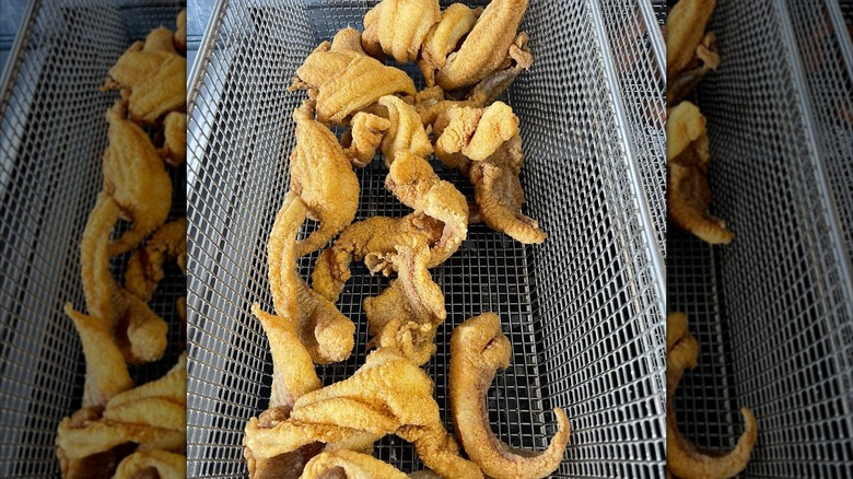 Pieces of fried catfish in a fryer basket
