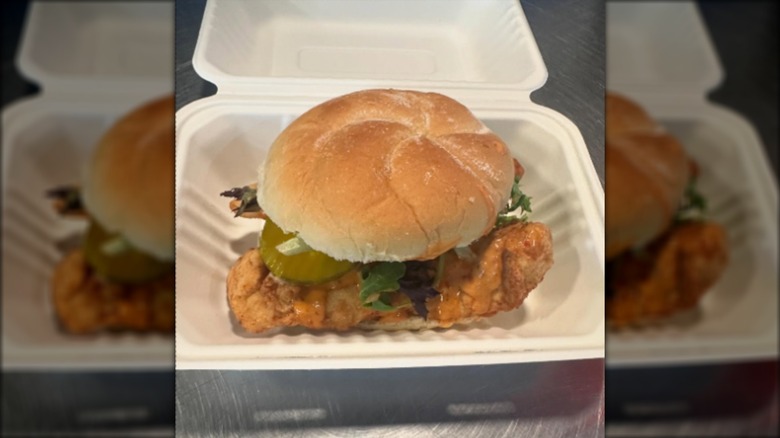 Fried cod sandwich in white tray