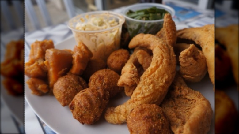 Plate with assortment of fried fish, coleslaw, and greens