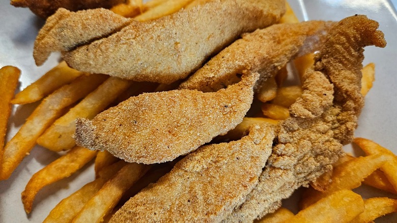 Fried catfish on a pile of fries