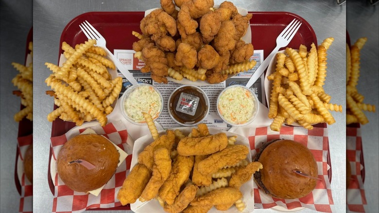 Tray of fried fish, sandwiches, fries, and coleslaw cups