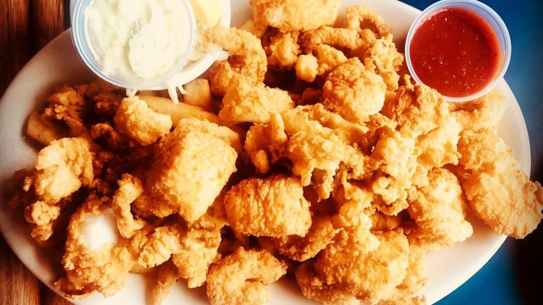Close-up of Fisherman's Platter dish from Boston Sail Loft, consisting of fried seafood and dipping sauces