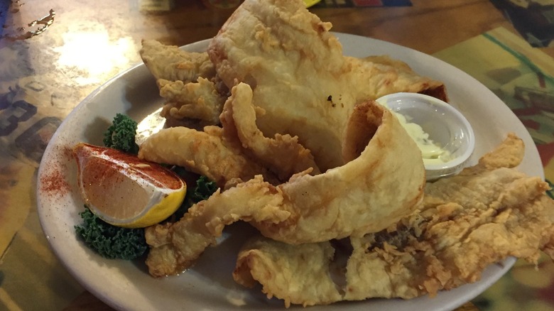 Plate of fried fish filets with slice of lemon