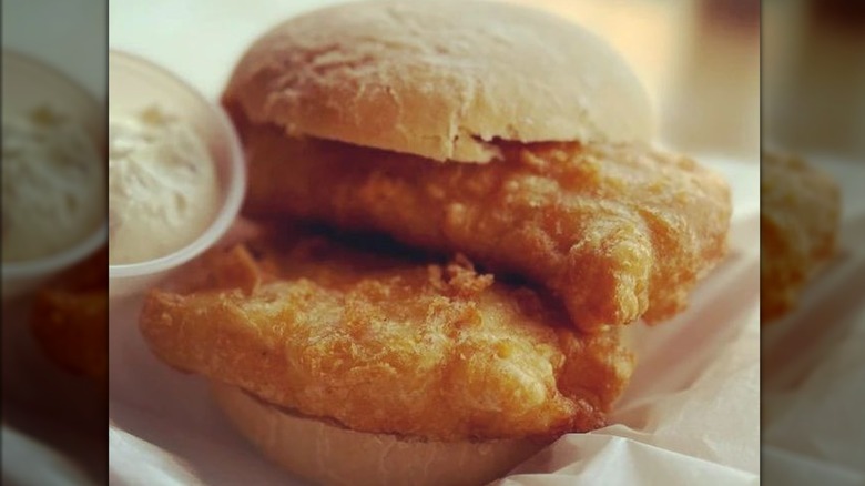 Pieces of fried fish on bread roll