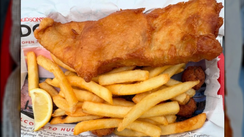 Fish and chips with lemon on newsprint