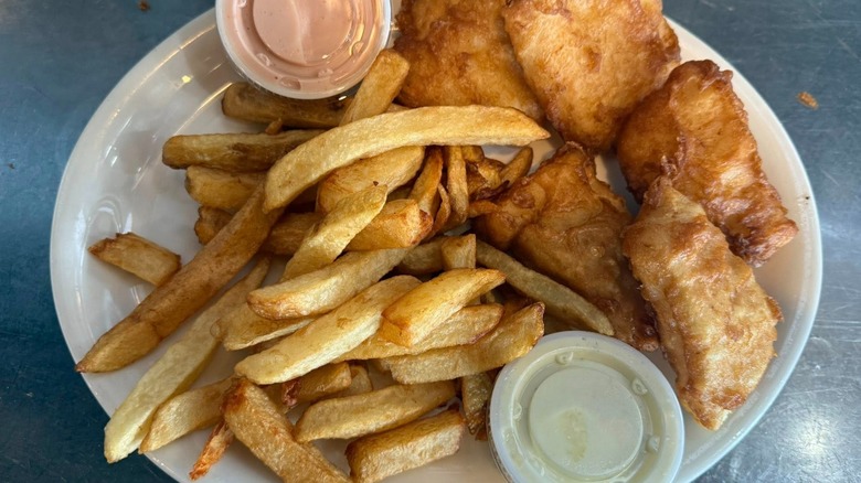 Plate of fish and chips on stainless steel table