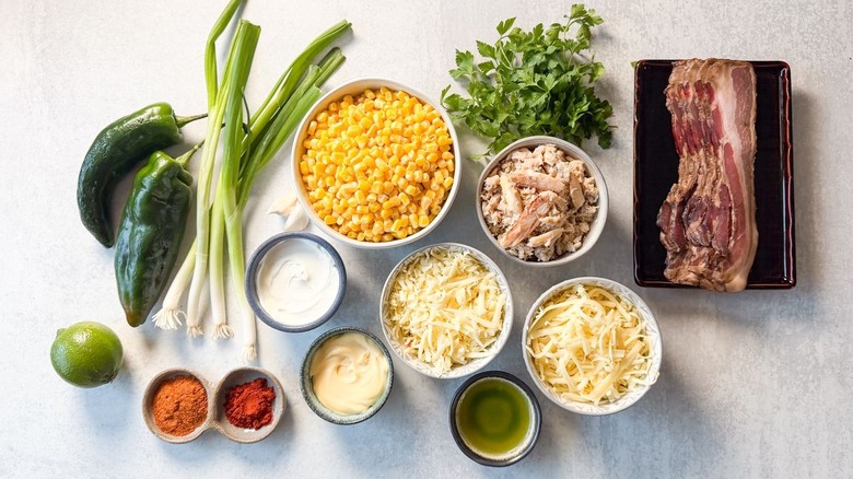 Best game day cheesy crab dip in cast iron skillet with veggie and tortilla chip dippers