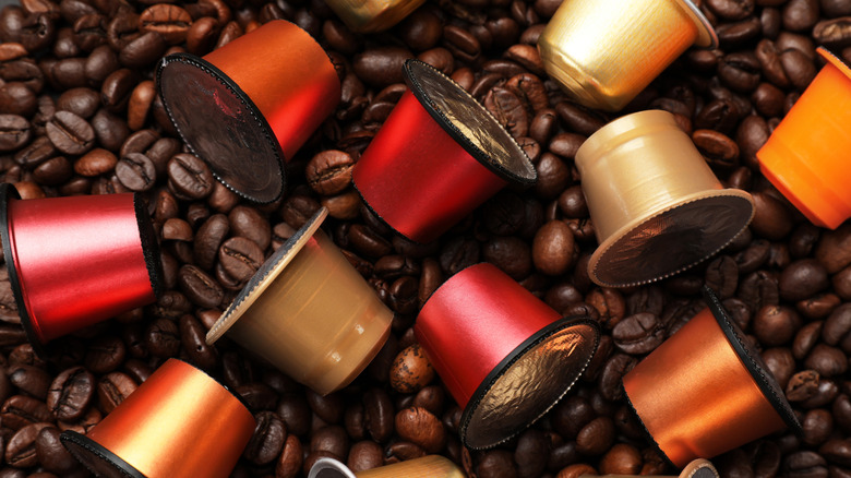 Coffee pods over coffee beans