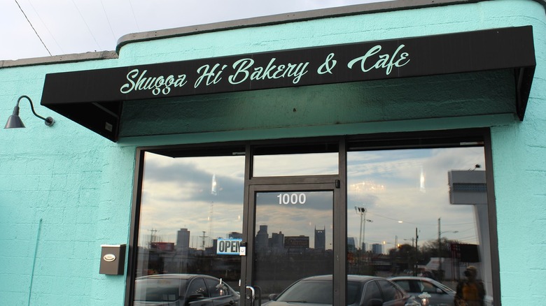 Front doors and brick exterior painted light blue at Shugga Hi Cafe