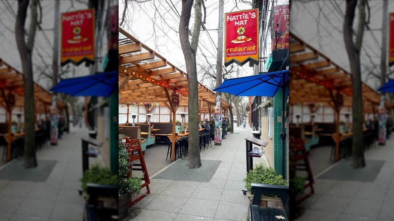 Side shot showing the doorway to Hattie's Hat and, across the sidewalk, the restaurant's outdoor patio