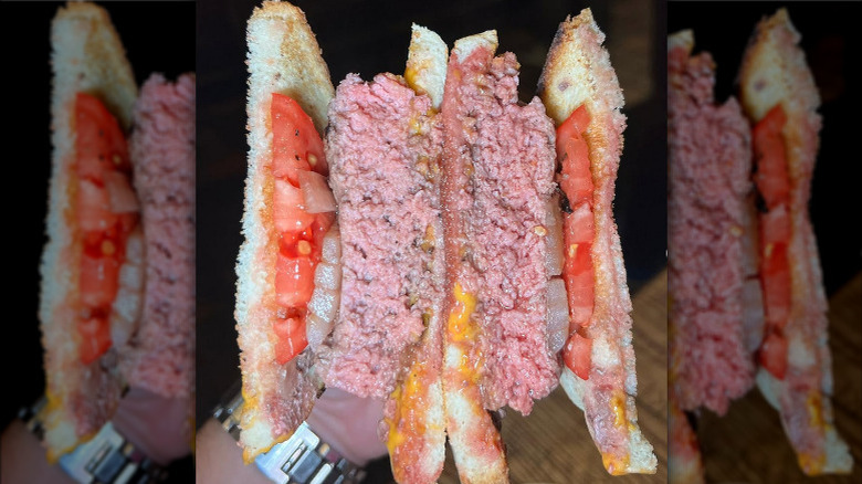 A burger on white bread from Louis' Lunch